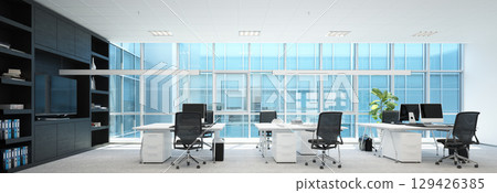 Modern office interior with empty desks chairs and computers in a spacious room. Contemporary workspace design for corporate business. 129426385