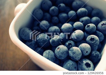 Frozen blueberries in an enamel container Frozen blueberries in an enamel container 129426956