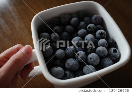 Frozen blueberries in an enamel container Frozen blueberries in an enamel container 129426966