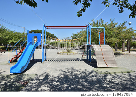 Playground equipment in the park illuminated by the midsummer sun 129427094