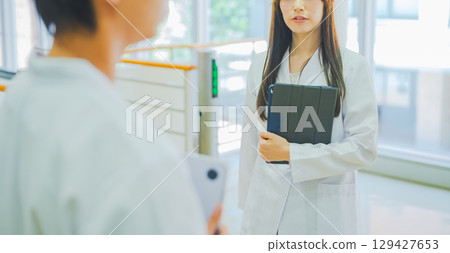 Men and women in white coats Men and women in white coats 129427653
