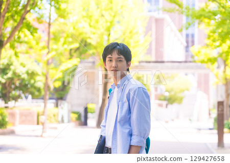 A male student looking back in the greenery A male student looking back in the greenery 129427658