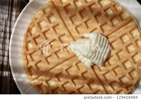 Crispy waffles topped with butter Crispy waffles topped with butter 129428469