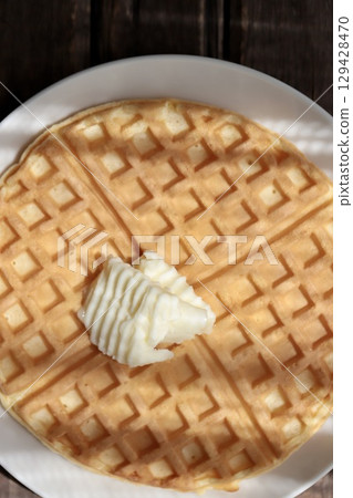 Crispy waffles topped with butter Crispy waffles topped with butter 129428470