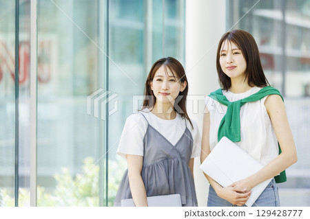 Students standing in a university classroom Students standing in a university classroom 129428777