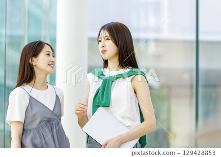 Smiling students standing in a university classroom Smiling students standing in a university classroom 129428853