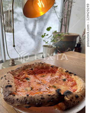 A condensed window in winter and a freshly baked pizza Margherita A condensed window in winter and a freshly baked pizza Margherita 129429249