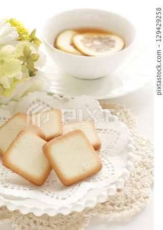 Langue de chat sweets and lemon tea Langue de chat sweets and lemon tea 129429258