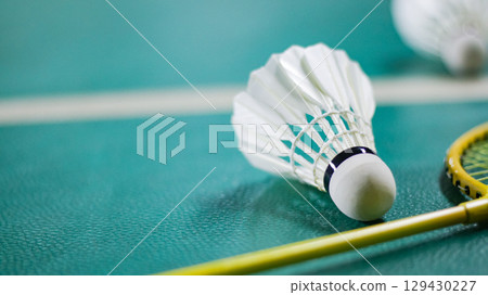 Shuttlecock and Racket on Badminton Court Background 129430227