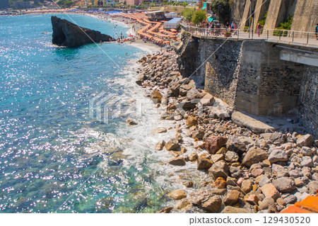 Summer Italian holidays on the coast of the Ligurian blue Sea and Mountain rock. Liguria Monterosso. Stones Beach 129430520