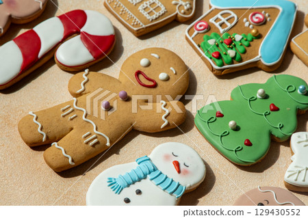 Gingerbread cookies with icing decoration. Christmas food. Gingerbread man snowman bake. Top view table. Xmas sweet background 129430552