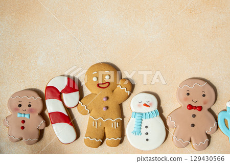 Gingerbread cookies with icing decoration. Christmas food. Gingerbread man snowman baking. Top view table. Xmas sweet copy space background Gingerbread cookies with icing decoration. Christmas food. Gingerbread man snowman baking. Top view table. Xmas sweet copy space background 129430566