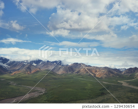 Alaska Landscape with Snowy Mountains and Cloudy sky. 129430654