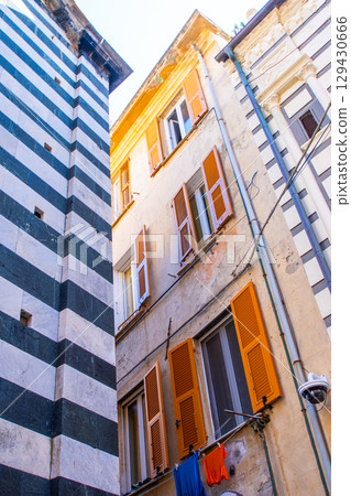Orange Shutters on the windows. Colorful houses buildings. Monterosso Italian village. Cinque Terre narrow street architecture, Liguria, Italy. 129430666