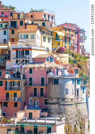 Multicolored houses on cliff edge. Manarola Italian village Cinque Terre, Liguria, Italy city architecture 129431086