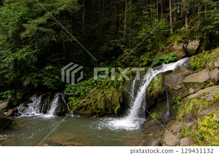 Mountain waterfall in the forest. Green nature. 129431132