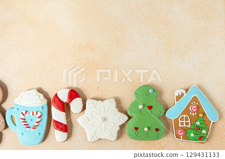 Gingerbread cookies with icing decoration. Christmas food. Baking tradition festive treat. Top view table. Xmas sweets copy space background 129431133