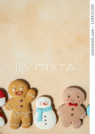 Gingerbread cookies with icing decoration. Christmas food. Gingerbread man baking. Top view table. Xmas sweet copy space background Gingerbread cookies with icing decoration. Christmas food. Gingerbread man baking. Top view table. Xmas sweet copy space background 129431200