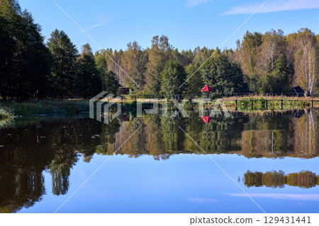 Serene Forest Lake with Wooden Bridge Reflection Serene Forest Lake with Wooden Bridge Reflection 129431441