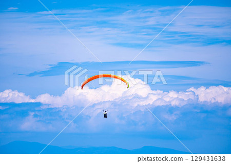 A paraglider flying over the sky 129431638