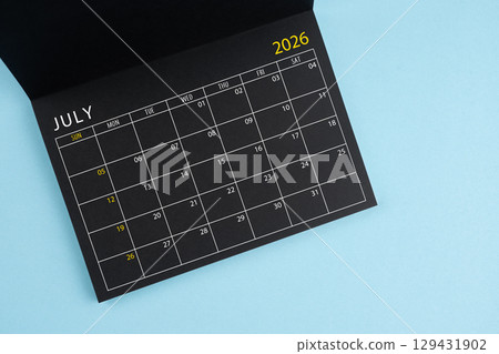 July 2026 Black calendar opening on blue color background. 129431902