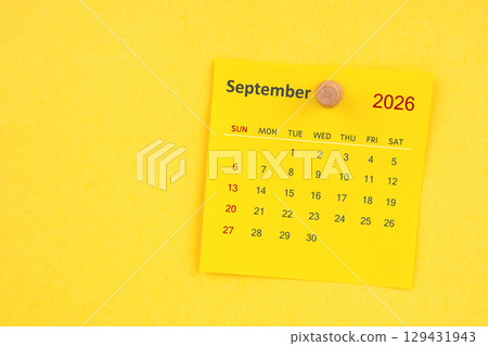 September 2026 calendar sheet with thumbtack on yellow color background. 129431943