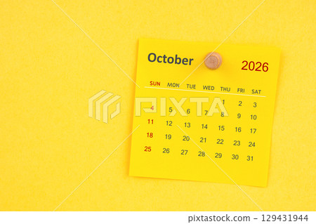 October 2026 calendar sheet with thumbtack on yellow color background. October 2026 calendar sheet with thumbtack on yellow color background. 129431944