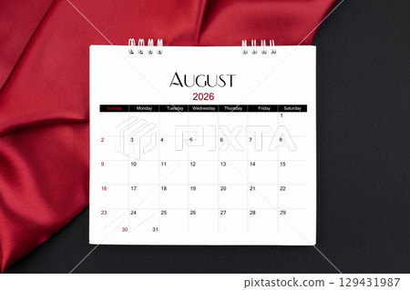 August 2026 Monthly desk calendar with red silk on black color leather background. 129431987