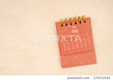 July 2026 red color mini calendar on old brown paper. 129432084