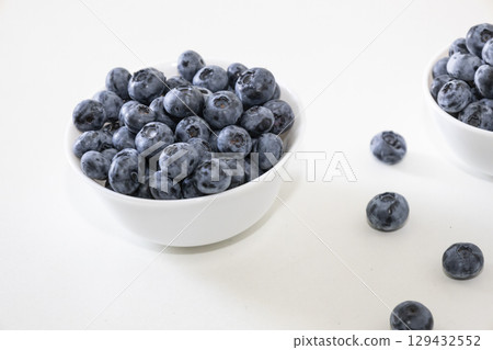 Blueberry is tasty, healthy and delicious fruits. Fresh blueberries  in white bowl. Wild blueberries in white plate on white background. 129432552