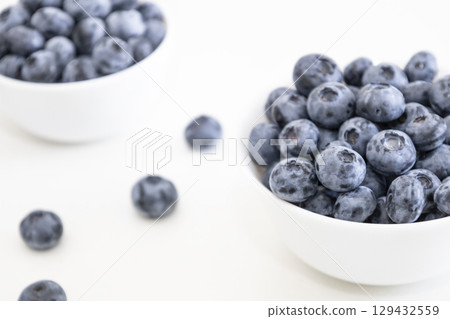 Blueberry is tasty, healthy and delicious fruits. Fresh blueberries in white bowl. Wild blueberries in white plates on white background. Blueberry is tasty, healthy and delicious fruits. Fresh blueberries in white bowl. Wild blueberries in white plates on white background. 129432559