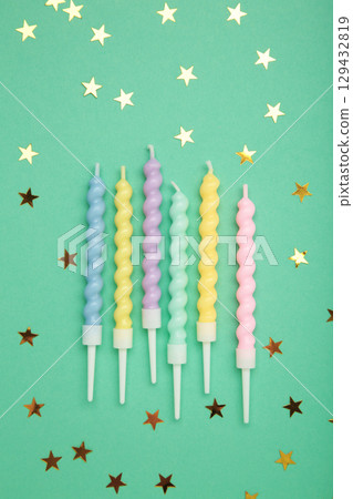 Candles with gold stars on mint background. Vertical photo Candles with gold stars on mint background. Vertical photo 129432819
