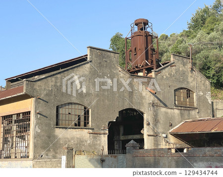 Buildings of old factory. Ruins and rusty structures. Old dilapidated building and nature. Buildings of old factory. Ruins and rusty structures. Old dilapidated building and nature. 129434744