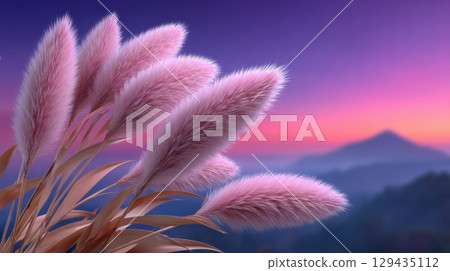 Soft pink pampas grass sways gently under serene pastel sunset, with blurred mountain in background creating tranquil scene 129435112