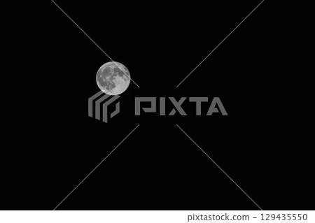 Full moon in a black night sky close up 129435550