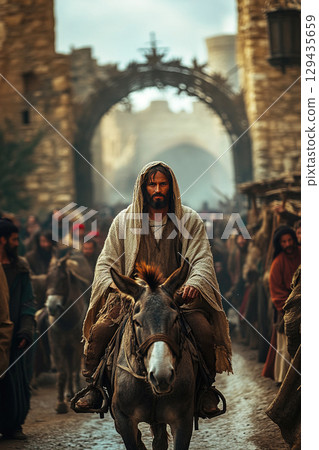 Jesus Christ enters Jerusalem on a donkey during a historic moment in religious narrative 129435659