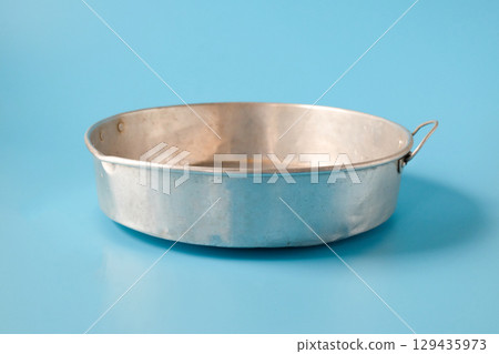 Old Metal baking tray on color background. Old Metal baking tray on color background. 129435973