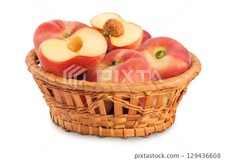 chinese flat donut peaches in a wicker basket isolated on white background 129436608