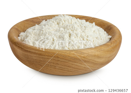 White flour in wooden bowl isolated on white background White flour in wooden bowl isolated on white background 129436657