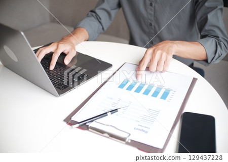 Closeup hand of unrecognisable businessman, accountant, banker working on desk at the workplace. 129437228