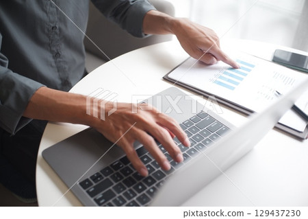 Closeup hand of unrecognisable businessman, accountant, banker working on desk at the workplace. Closeup hand of unrecognisable businessman, accountant, banker working on desk at the workplace. 129437230
