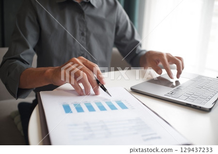 Closeup hand of unrecognisable businessman, accountant, banker working on desk at the workplace. 129437233
