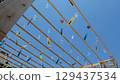 Many wind chimes shining against the blue sky 129437534