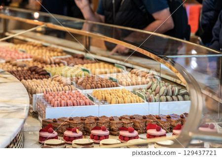 Various assortment of desserts confectionery on the counter in a bakery Various assortment of desserts confectionery on the counter in a bakery 129437721