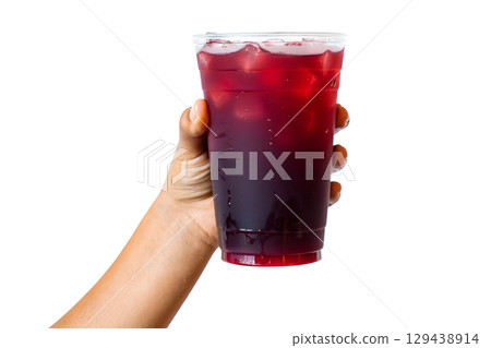 Hand holding refreshing iced beverage in clear cup, cold summer drink with condensation droplets 129438914