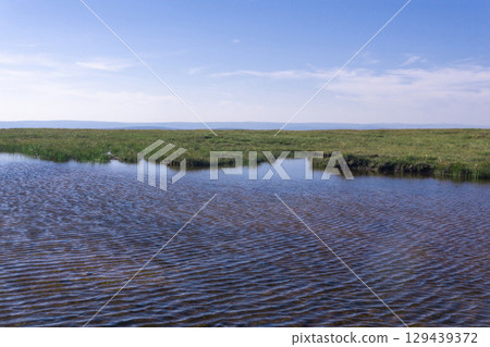 shallow lake on a high mountain plateau shallow lake on a high mountain plateau 129439372