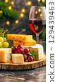 Cheese, wine and grapes on a Christmas background 129439463