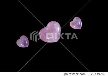 Macro mineral stone Heart pink quartz on a black background Macro mineral stone Heart pink quartz on a black background 129439702