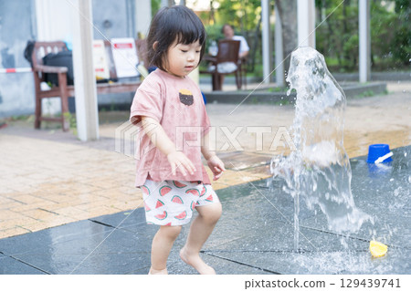 Japanese toddlers playing in the fountain at the apartment complex 129439741
