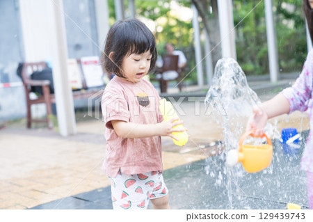 Japanese toddlers playing in the fountain at the apartment complex 129439743